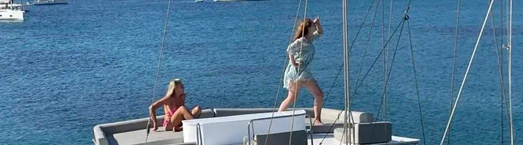 Femmes profitant du soleil sur le pont d’un voilier en Grèce lors d’une croisière entre amies avec skipper